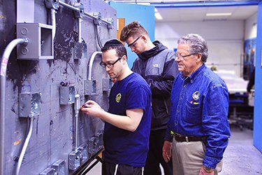 Electrical Students Repairing Panel